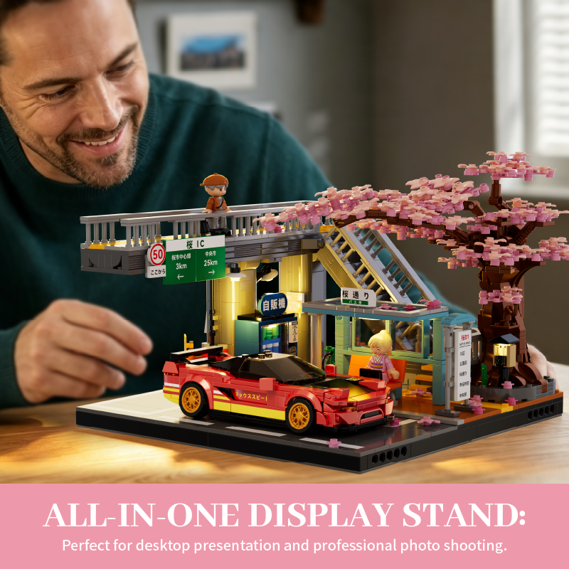 Adult builder displaying Sakura Station and Skybridge on a desk